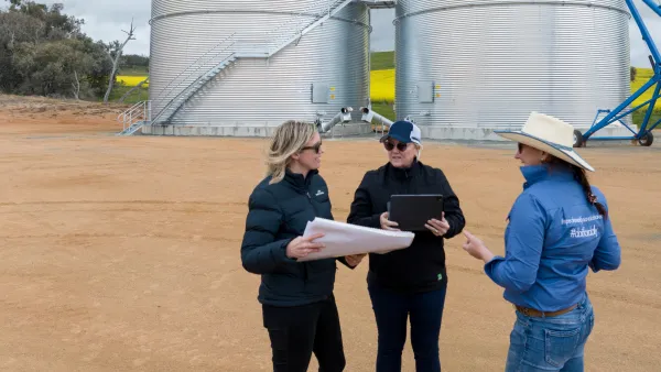 Crisis comms scenario exercise 3 women standing in front of silos